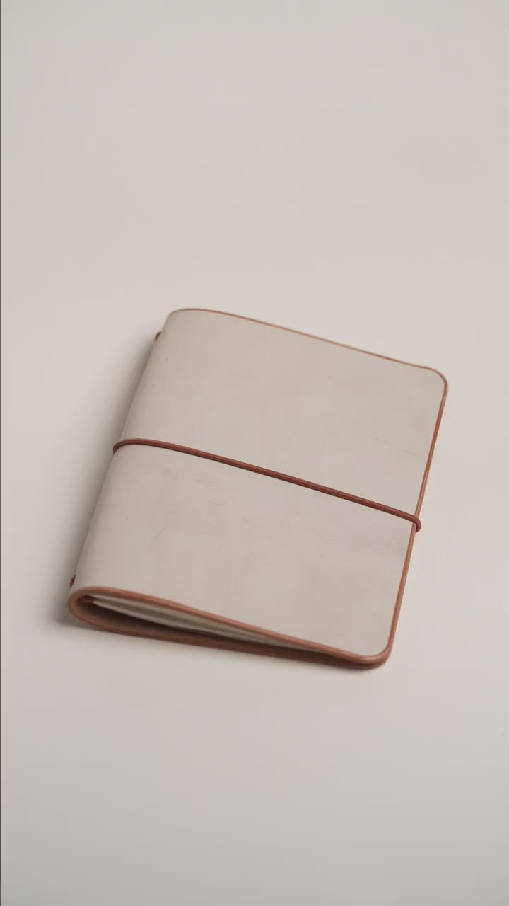 Undyed Ghost Wax A6 cover, pale wax bloom over natural leather