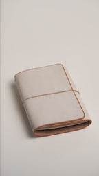 Undyed Ghost Wax A6 trifold cover, wax bloom across the wrap