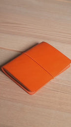 Rust-orange Buttero A6 cover, the finished piece in the workshop