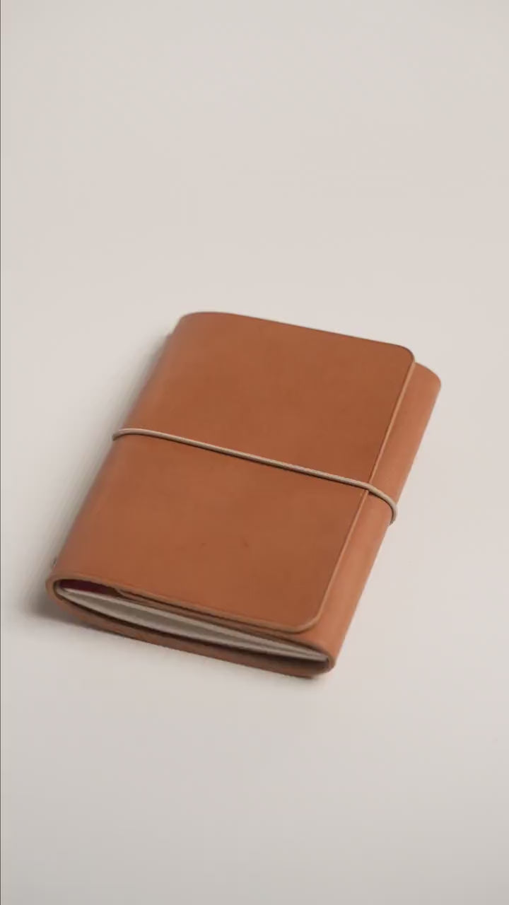 Camel tan Buttero A6 trifold cover, the finished piece in the workshop
