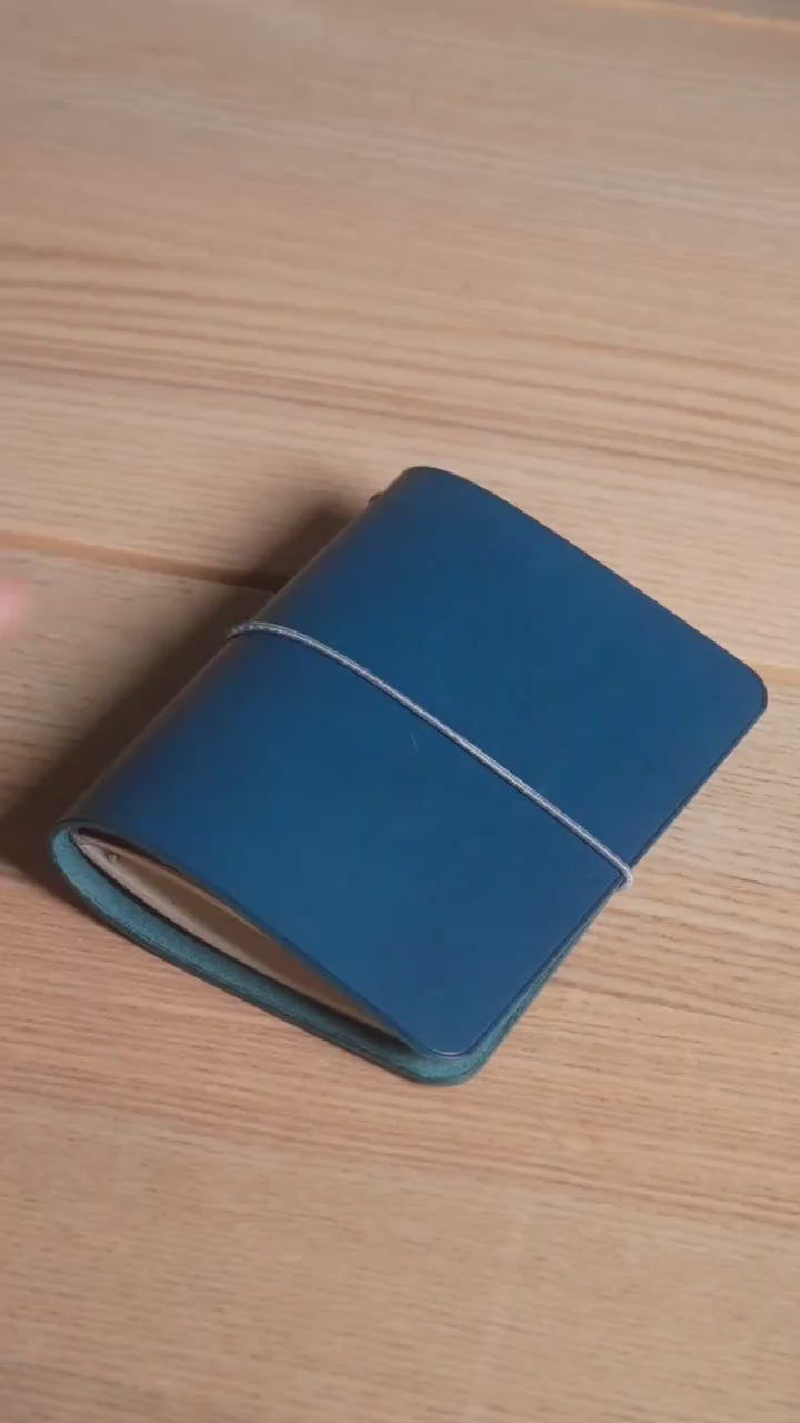 Navy Buttero A6 cover, near-black until the light finds the blue