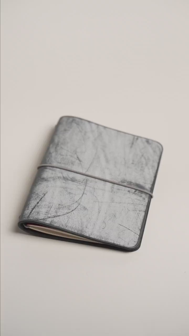 Black Ghost Wax A6 cover, pale frosted wax over a deep black hide