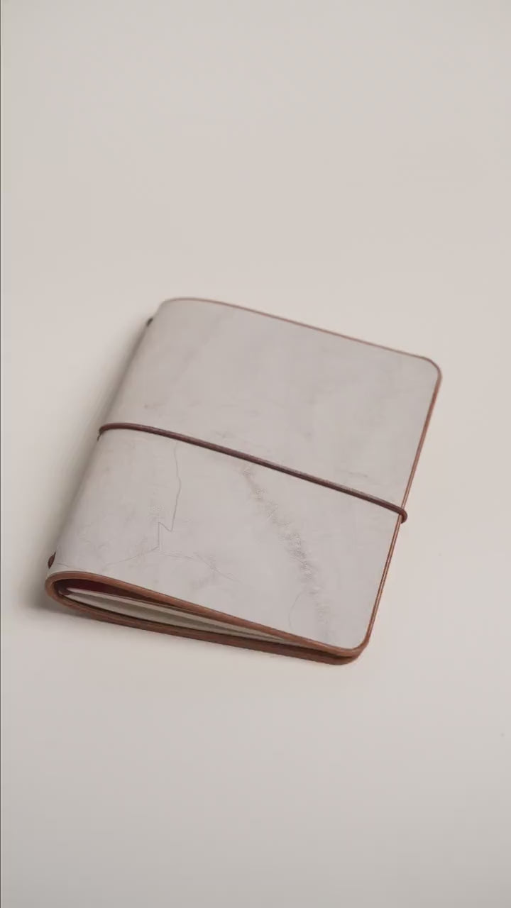 Light brown Ghost Wax A6 cover, frosted layer over warm brown leather